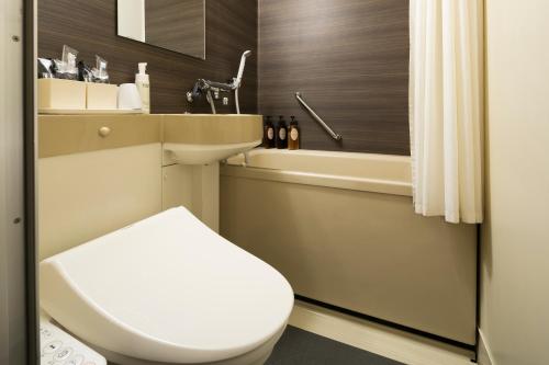 冈山Ark Hotel Okayama -ROUTE INN HOTELS-的浴室配有卫生间、盥洗盆和浴缸。