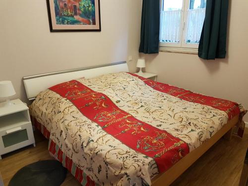 Frauenberg莱斯贵妇人德拉蒙塔涅公寓的床上有红白毯子