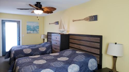 普廷贝Put-in-Bay Waterfront Condo #207的一间卧室配有两张床和吊扇