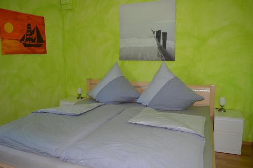 拉德贝尔根Ferienwohnung Gravemeier的一间卧室设有一张带绿色墙壁的大床