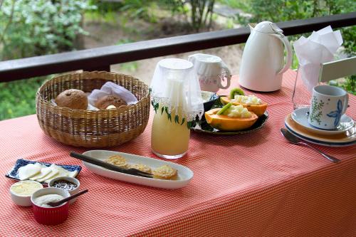 伊尔哈德博伊巴Pousada Vila Sereia的一张桌子,上面有食物和一篮水果及果汁