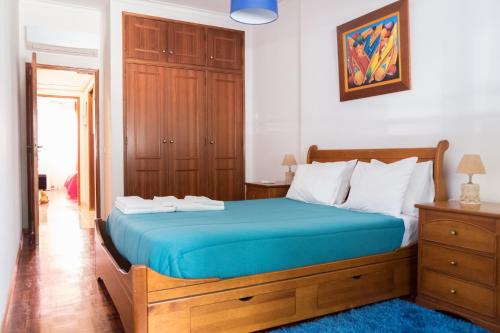 塔维拉Apartamento Tavira的一间卧室配有一张蓝色床垫的大床