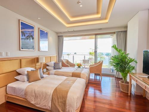 石垣岛石垣度假酒店的酒店客房设有两张床和电视。