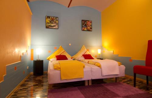 德累斯顿艺术公寓 的黄色和蓝色的客房内的两张床