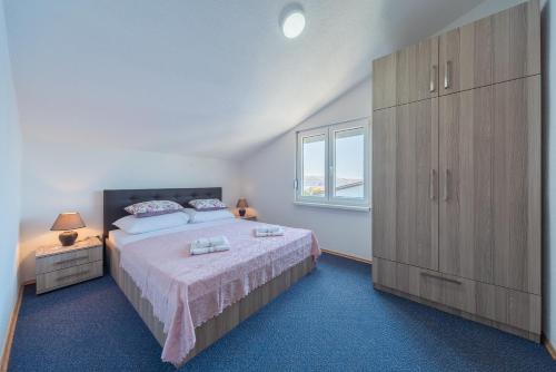卡尔卢巴格Apartmenthaus Hana的一间卧室配有一张大床和一个大型橱柜