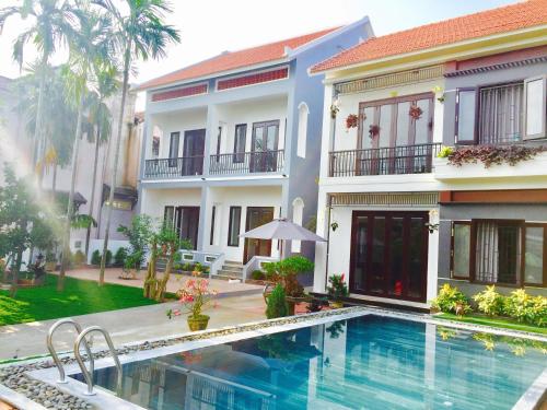 会安Yen villa Hội An的一座别墅,在一座建筑前设有一个游泳池