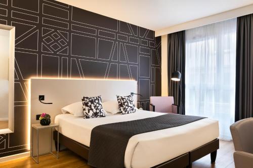 斯特拉斯堡馨乐庭斯塔伯格克雷贝酒店的一间卧室设有一张床和黑色的墙壁