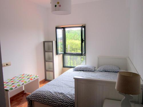 卡马里尼亚斯Xaviña Camariñas的一间卧室设有一张床和一个窗口
