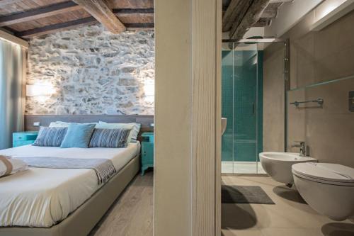 里奥马哲雷斯特里奥 - 旅馆的一间卧室配有一张床、一个浴缸和一个水槽