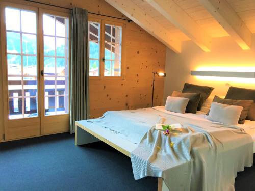 伦克Chalet ELK Lenk的一间卧室设有一张床和一个大窗户