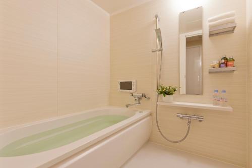 东京Hotel BIX的带浴缸、水槽和镜子的浴室