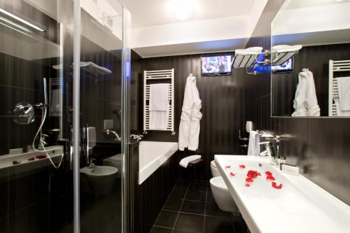 的里雅斯特Hotel Coppe Trieste - Boutique Hotel的一间带水槽、卫生间和镜子的浴室