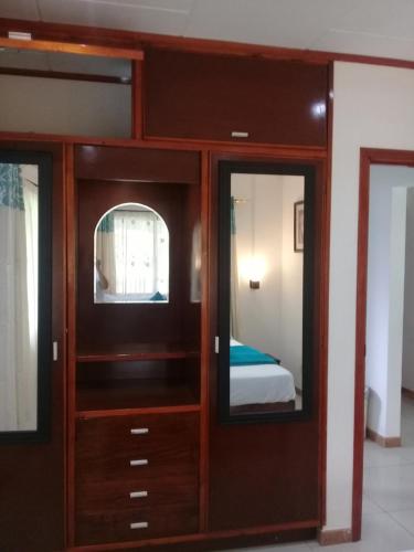 拉迪格岛Agnes Cottage的客房设有带两面镜子的木柜。