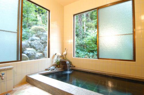 伊势原市渚山庄的带浴缸和窗户的浴室