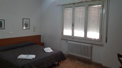 佛罗伦萨阿尔伯格索尼亚酒店的一间卧室设有一张床和一个窗口