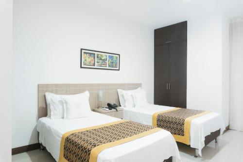 Hotel Cinco Monteria客房内的一张或多张床位