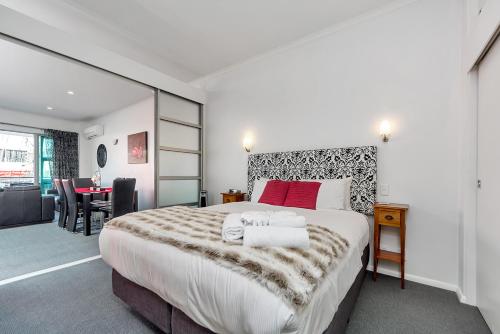 奥克兰QV Private Airconditioned Waterfront Apartment - 423的酒店客房设有一张大床和一张书桌。