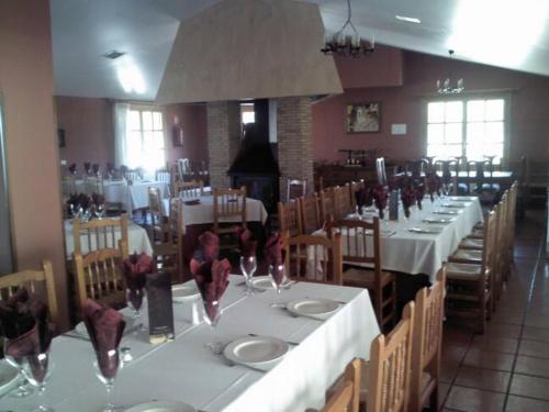 Vall dʼAlba勒尔米塔卡萨里波酒店的用餐室配有白色桌椅和酒杯