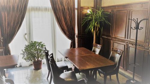 旧扎戈拉Хотел "АВЕНЮ"的一间带木桌和椅子的用餐室