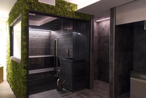 托尔博莱弗特魅力加尔达酒店的浴室设有墙壁上的绿色苔 ⁇ 淋浴。