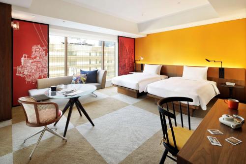 东京东京银座凯悦尚萃酒店的酒店客房设有两张床和一张桌子。