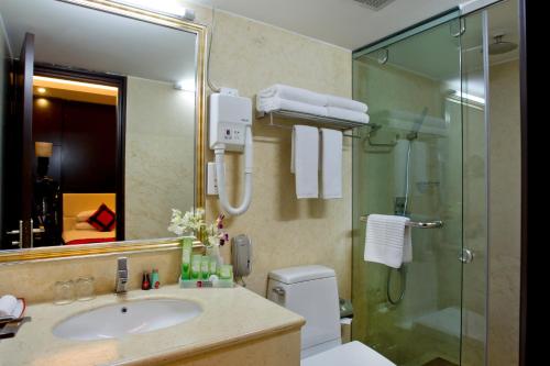 达卡INNOTEL BATON ROUGE - A Luxury Collection Hotel的一间带水槽和玻璃淋浴的浴室