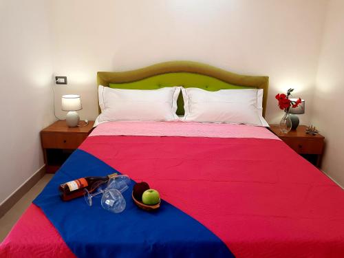 梵蒂冈角Mazzitelli Apartment的一间卧室配有一张带红色和蓝色毯子的床