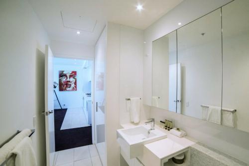 墨尔本The Sebel Melbourne Docklands Hotel的白色的浴室设有水槽和镜子