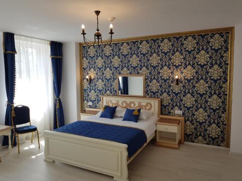锡比乌Vila Bohemia的一间卧室设有一张床和蓝色的墙壁