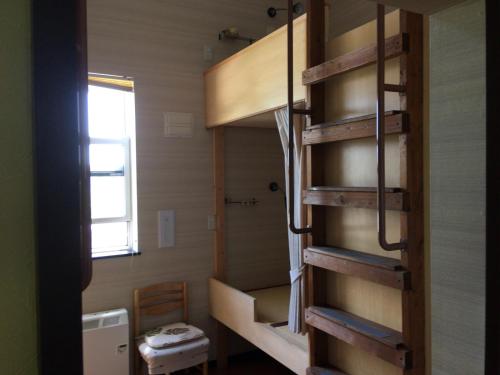 俱知安町Niseko Tabi-tsumugi Backpackers的小房间设有双层床和卫生间