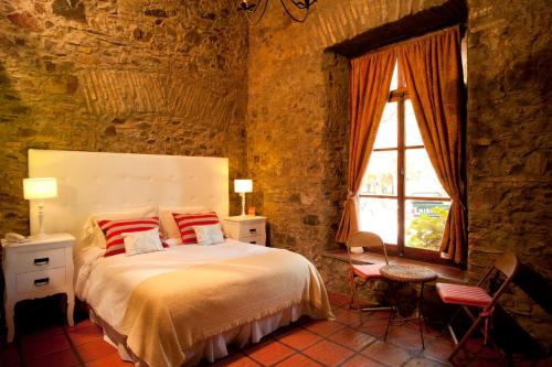 科洛尼亚-德尔萨克拉门托拉米圣酒店的一间卧室设有一张大床和一个窗户。