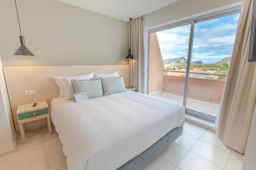 圣港维拉巴莱拉圣港酒店的一间卧室设有一张大床和一个大窗户