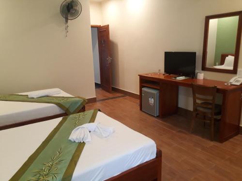岘港塔比伊酒店的客房设有两张床和一张带电脑的书桌