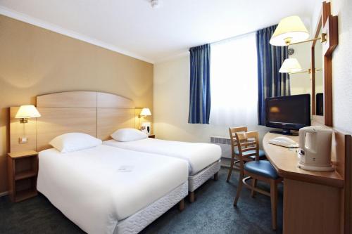 菲尔福尔德布鲁塞尔维尔福德钟楼酒店的酒店客房设有一张床、一张书桌和一台电视机。
