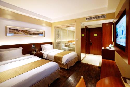 麦新格精品酒店川沙店客房内的一张或多张床位