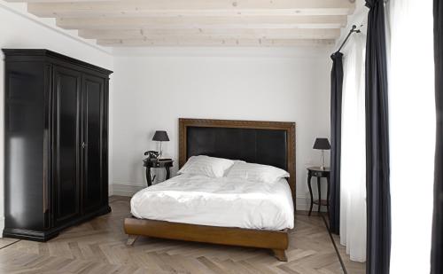 庞特内阿尔比拉坎达阿拉斯塔兹翁酒店的一间卧室配有一张大床和一个黑色橱柜