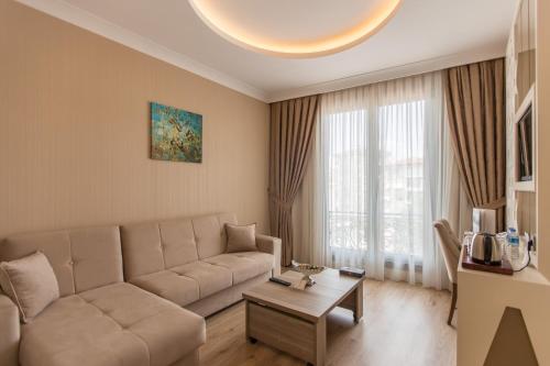 伊斯坦布尔The Grand Mira Business Hotel的客厅配有沙发和桌子