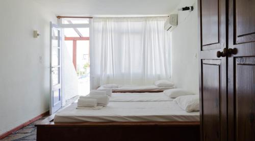 迈加洛丘里''The Boulas'' Rooms的带窗户的客房内的两张床