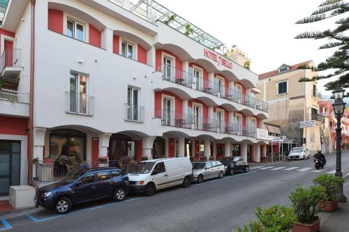 米诺利Hotel7Bello的一条在大楼前停放汽车的街道