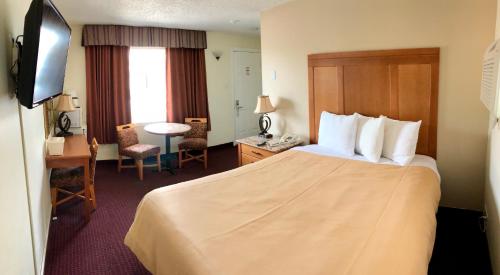 亨茨维尔亨茨维尔旅馆的配有一张床和一张书桌的酒店客房