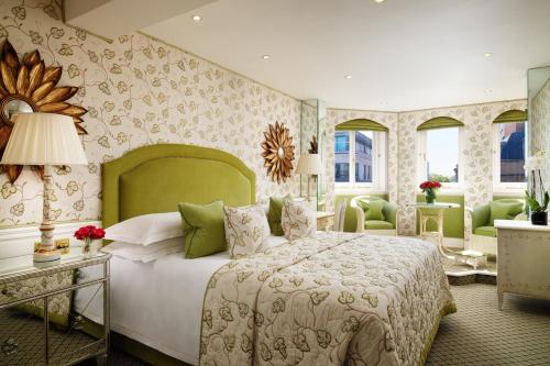 伦敦红色康乃馨切斯特菲尔德梅菲尔酒店的一间卧室配有一张大床和绿色床头板