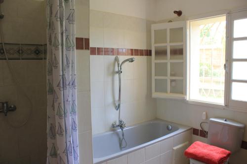 安齐拉贝马斯罗伊公寓式酒店的一间带浴缸和淋浴的浴室,并设有一个窗户