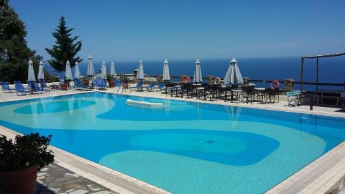 桑加拉达Pilio Sea Horizon Hotel的一个带椅子和遮阳伞的大型蓝色游泳池