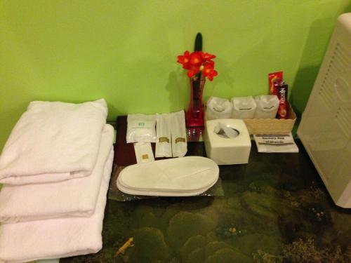曼谷槟城皇宫酒店的浴室配有卫生间、水槽和毛巾。