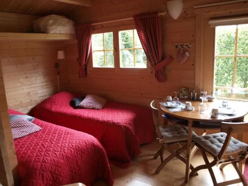 皮滕Bed En - of zonder - Breakfast Putten的一间卧室设有两张床、一张桌子和窗户。