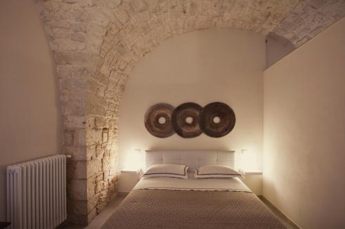 孔韦尔萨诺Dimora a Corte的一间卧室设有一张床和石墙