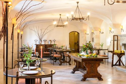 法萨诺马塞里亚马尔萨罗萨酒店的餐厅设有桌椅和吊灯。