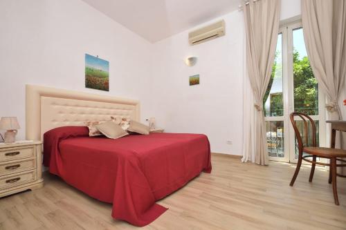 拉维罗Nicola e Magda的一间卧室配有红色的床和桌椅