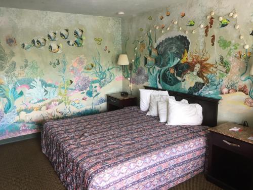 加洛韦Deluxe Inn的一间卧室配有一张壁画床