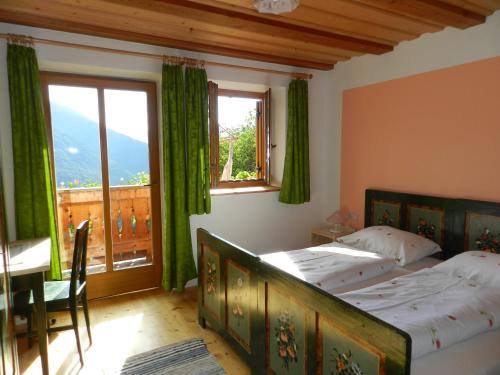 卢松Gedrarzerhof的一间卧室配有一张床、一张桌子和一个窗户。